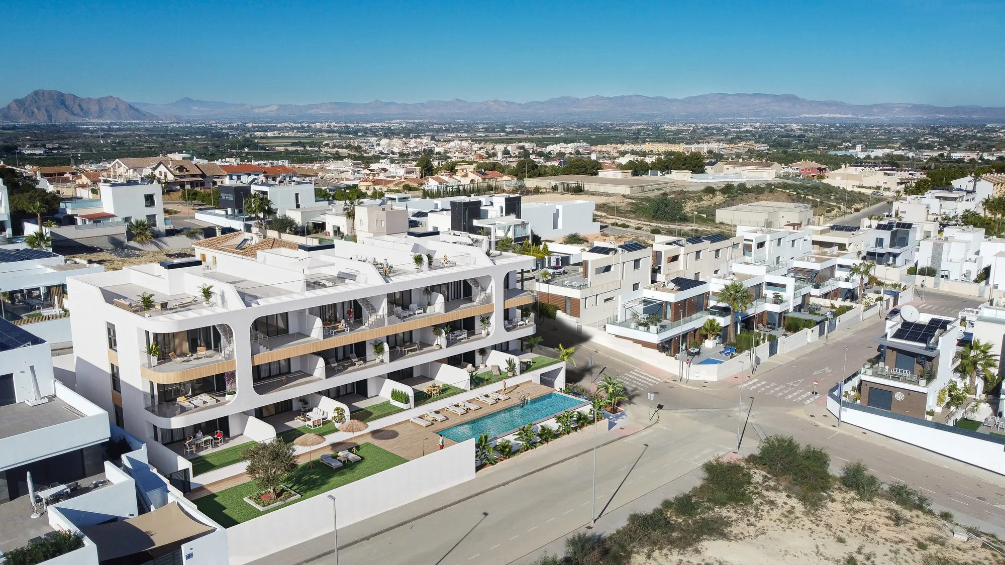 Aerial photomontage of Benisol II among white villas at the edge of Benijófar, with the pool, the Vega Baja plain and mountains on the horizon