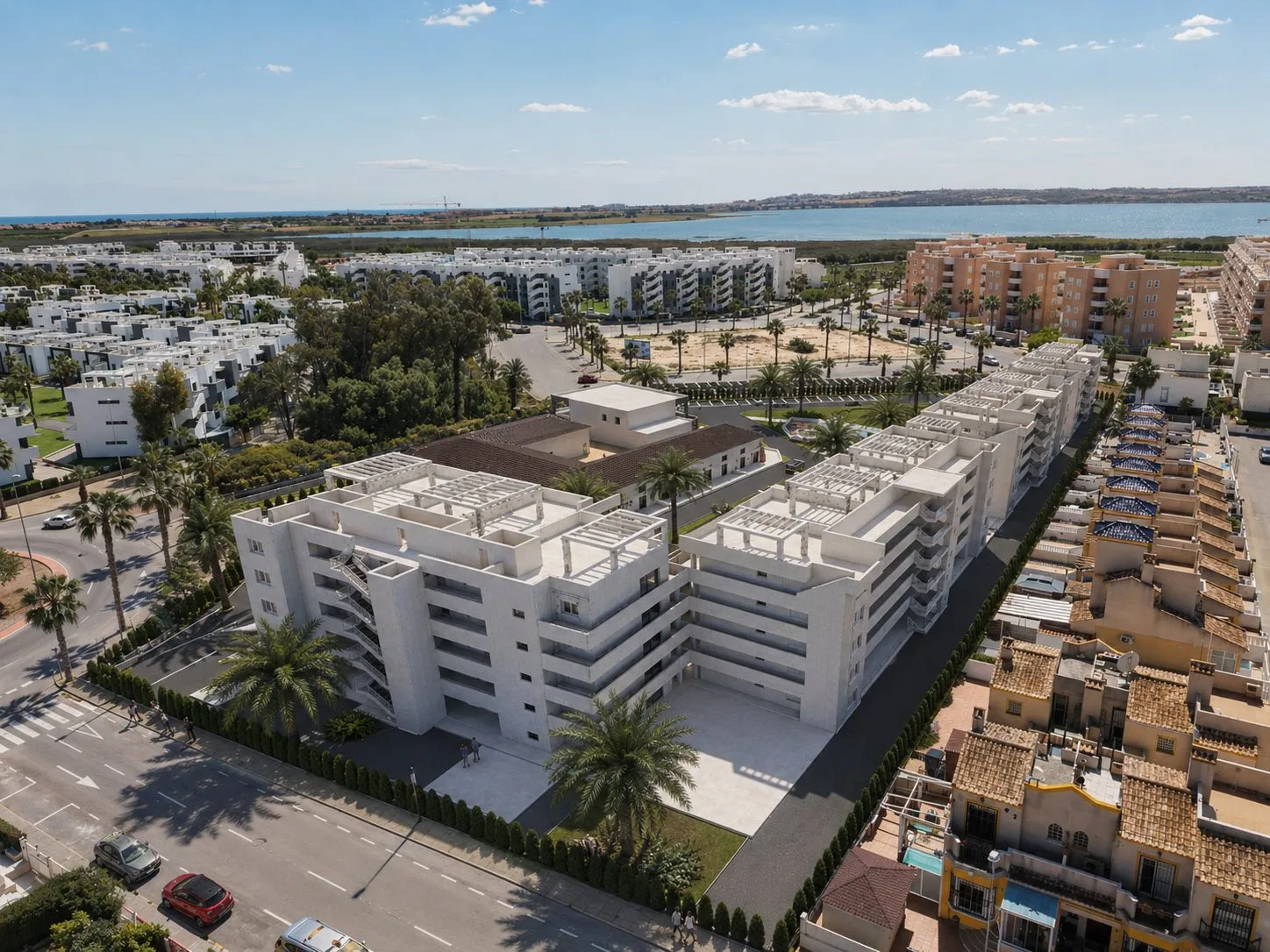 Aerial render of the Oasis Garden blocks showing the penthouse solariums and pergolas, with the lagoon and the sea in the distance