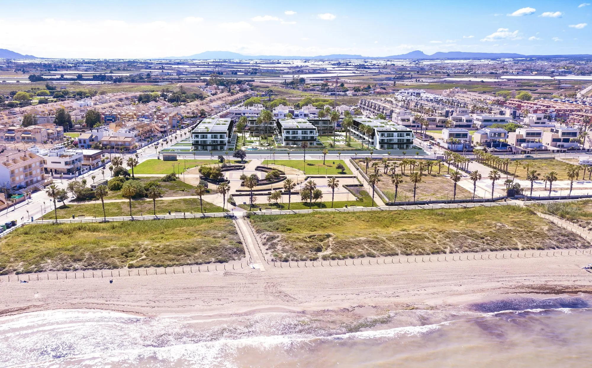 Render from Las Higuericas beach, with the sand, the dunes and the park, and the development’s blocks behind