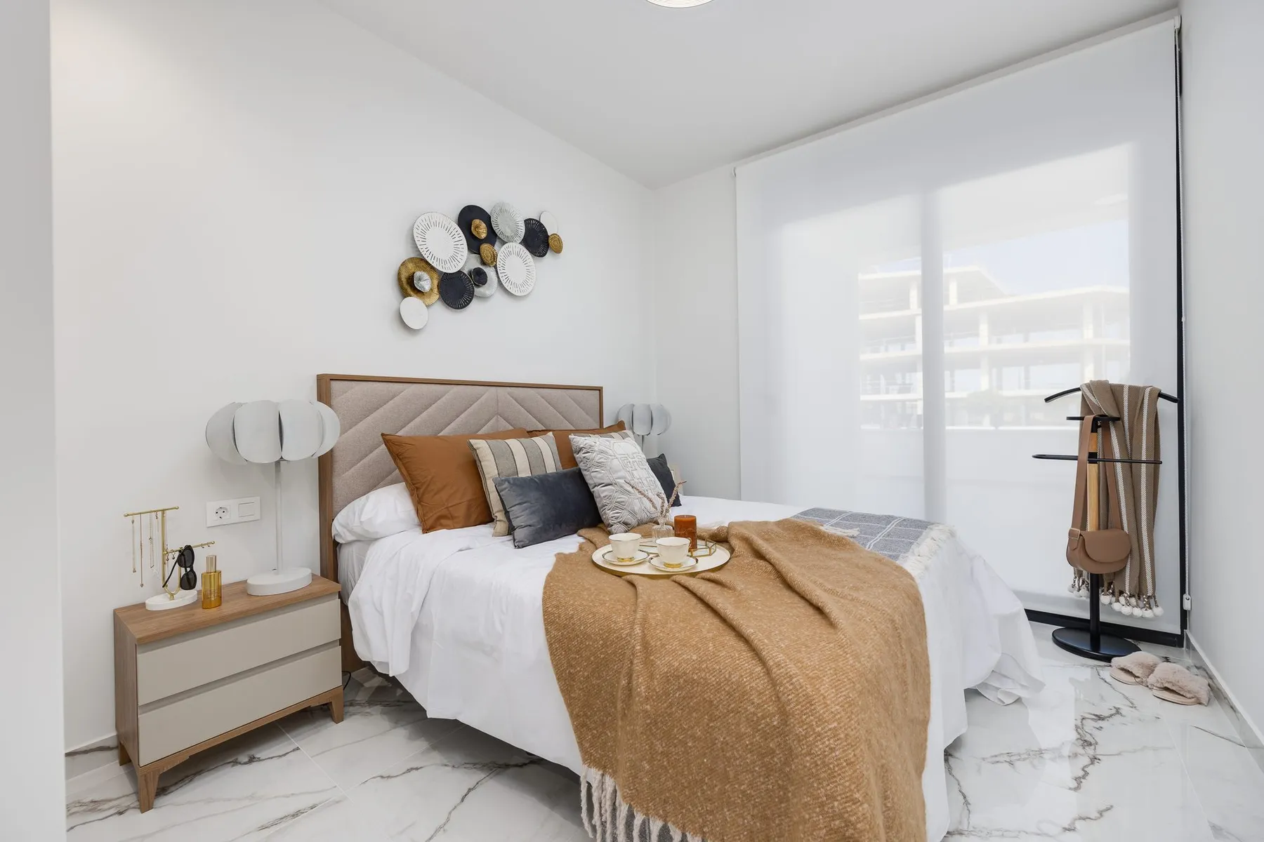 Main bedroom of Duly’s show house in San Miguel de Salinas, with a double bed and large window