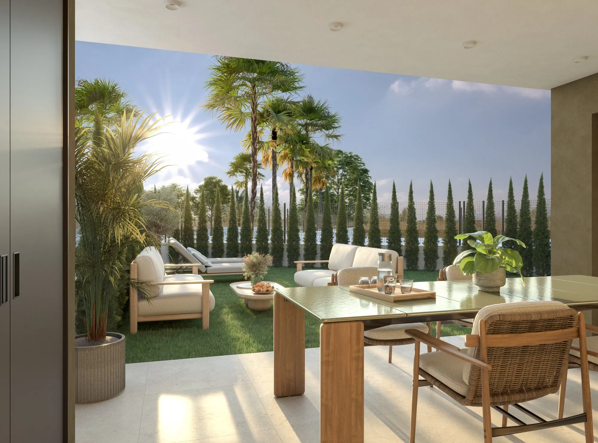 Render of the covered terrace of a ground-floor apartment, with a dining table, sofas and the private garden with palms and cypresses