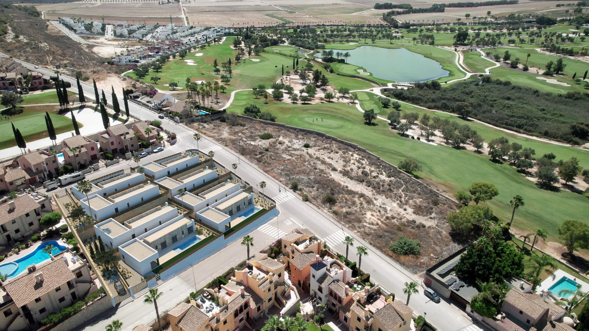 Aerial render of the eight villas with their pools, next to the La Finca golf course and its lake