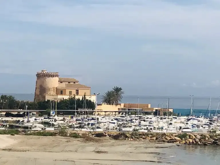 The watchtower of Torre de la Horadada beside the marina