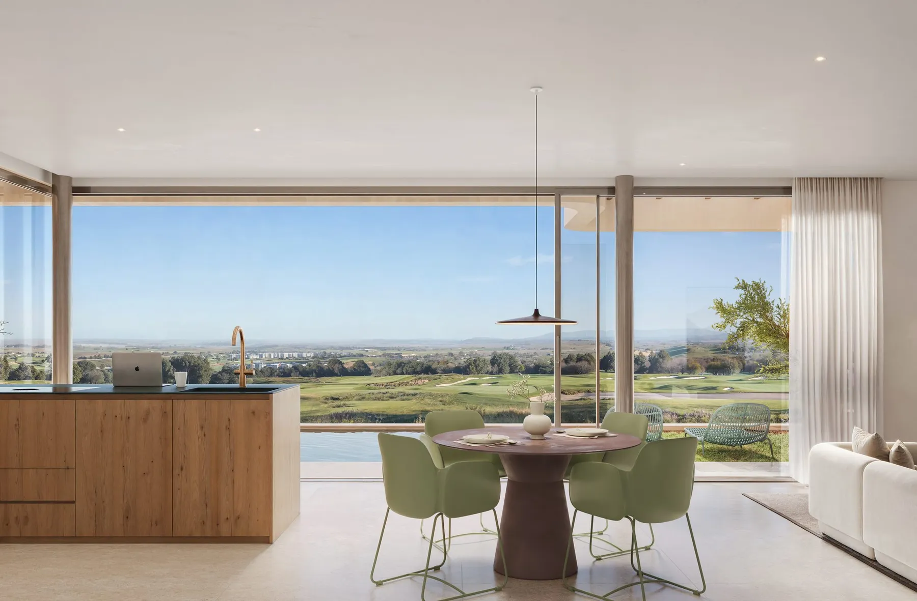 Render of a villa’s open kitchen with a wooden island and a round table with green chairs, facing floor-to-ceiling glass with views of the golf course
